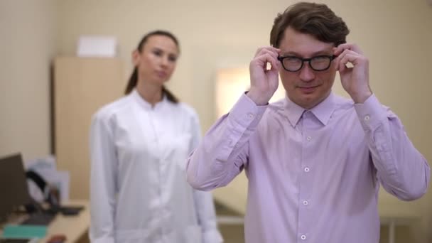 Satisfied Male Patient Standing Right Putting Eyeglasses Smiling Looking Camera — Stock video