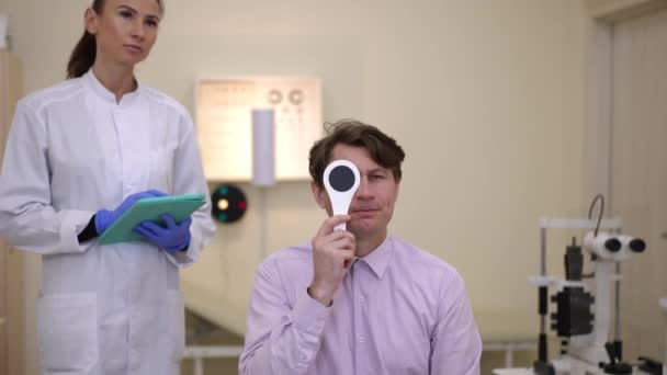 Front View Concentrated Caucasian Man Closing One Eye Squinting Reading — Stock video