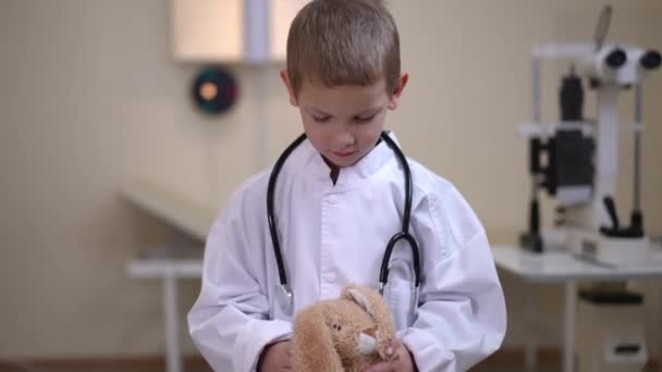 Portrait Little Boy Medical Uniform Standing Toy Hospital Looking Camera — Stock videók