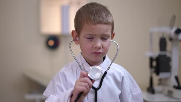 Charming Child Toothy Smile Standing Hospital Stretching Stethoscope Posing Portrait — Stock video