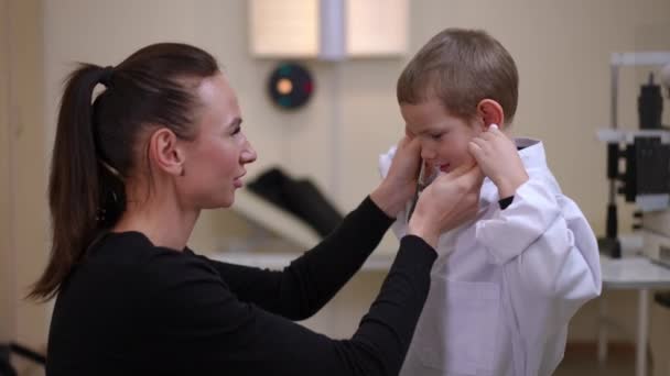Positive Woman Passing Stethoscope Boy Listening Auscultation Standing Hospital Indoors — Vídeo de Stock