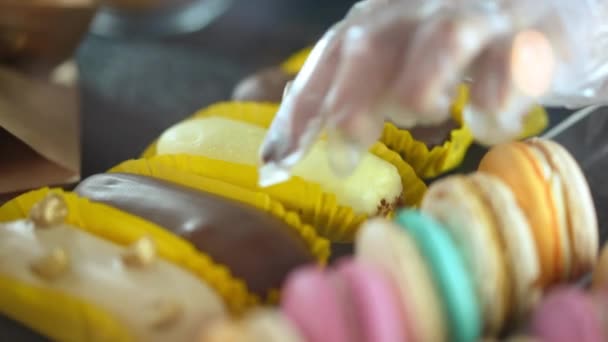 Close Colorful Delicious Eclairs Doughnuts Coffee Shop Female Hand Glove — Vídeo de stock