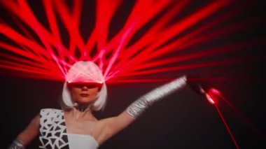Portrait of slim Caucasian woman with red laser beam on eyeglasses dancing at black background. Talented skilled confident dancer in futuristic cyber costume performing modern art
