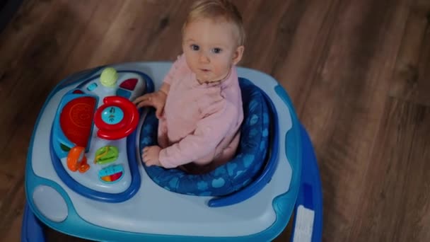 High Angle View Cute Curios Baby Girl Playing Baby Walker — Stok Video