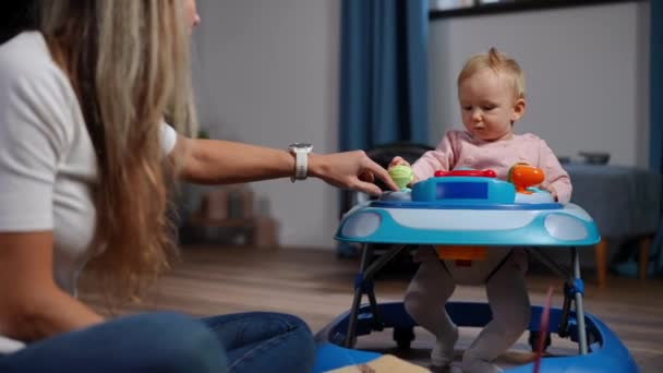 Adorable Caucasian Baby Girl Baby Walker Right Looking Woman Pressing — Wideo stockowe