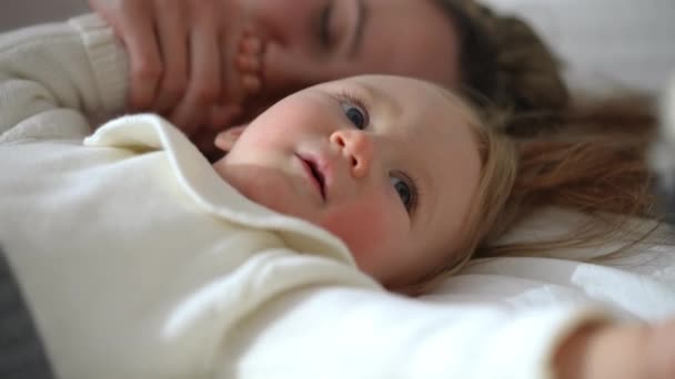 Headshot Curios Adorable Baby Girl Playing Toy Blurred Woman Kissing — Vídeos de Stock