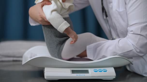 Side View Unrecognizable Pediatrician Putting Baby Girl Scales Slow Motion — Stock videók