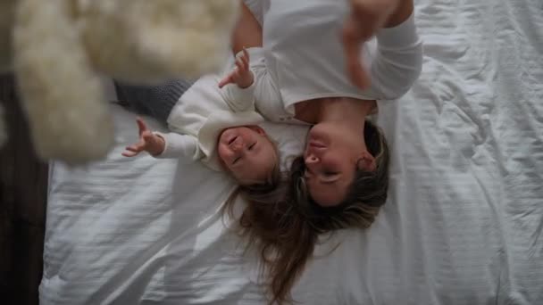 Top View Laughing Mother Baby Daughter Playing Teddy Bear Lying — Stock videók