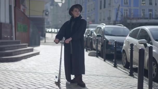 Wide Shot Portrait Confident Woman Cloak Hat Standing Kick Scooter — Stok video