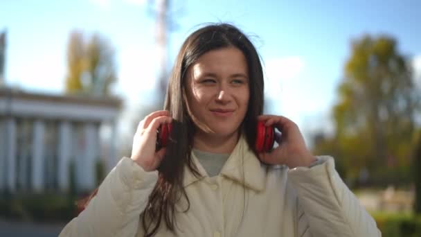 Satisfied Young Caucasian Woman Taking Headphones Looking Standing Sunny City — Stock Video