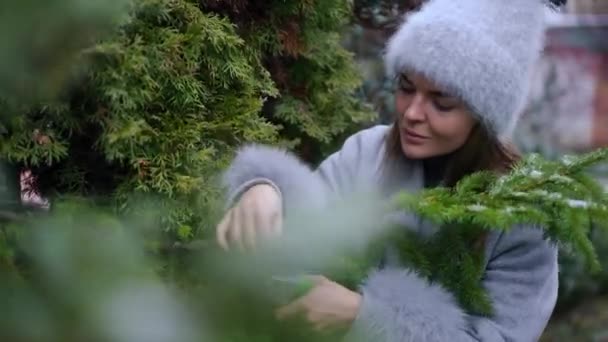 Positive Young Charming Caucasian Woman Choosing Branches Handmade Christmas Wreath — Stock Video