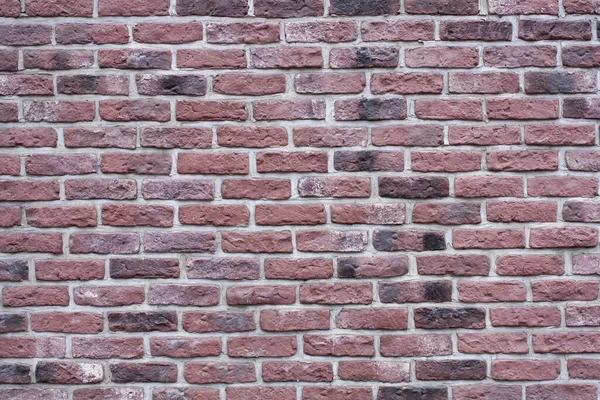 Koyu kırmızı tuğlalı eski bir duvarın desenli arka planı