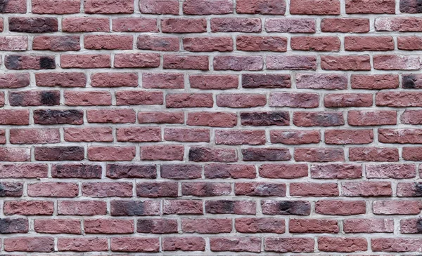 Koyu kırmızı tuğla duvarın kusursuz dokusu. Eski tuğla işi.