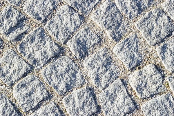 Textura de fundo de alvenaria com areia em costuras entre pedras de pavimentação. Linhas circulares. — Fotografia de Stock