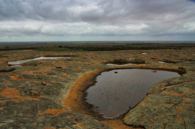 Pools in the granite, lichen-covered Polda Rock Reserve, that originally supplied water to Wudinna Township, Eyre Peninsula, South Australia
