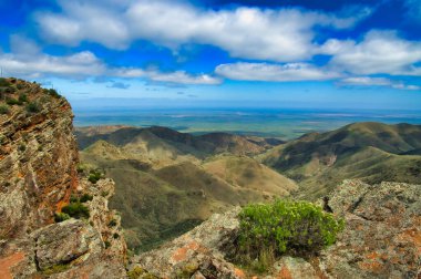 View from Dutchmans Stern, at the south end of the Flinders Range in South Australia. Bare rock, lichen, barren hills and in the distance the flat country between the coast and the outback