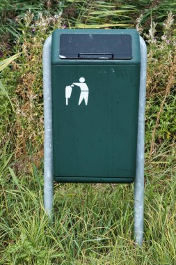 Green garbage bin with a stylized image of a person throwing garbage into a trash can.