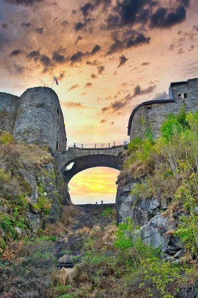 Dramatic evening sky above the bridge to the medieval castle of Bouillon, province of Luxemburg, Belgium. Low camera standpoint