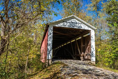 Wilkins Değirmen Kaplama Köprüsü, Indiana, Parke County 'deki Bloomingdale yakınlarında sonbahar yapraklarının renk değişimi sırasında Sugar Creek' i geçer..