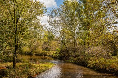 The Ashtabula River viewed from the Benetka Road Covered Bridge during the Autumn leaf color change in Ashtabula County, Ohio.