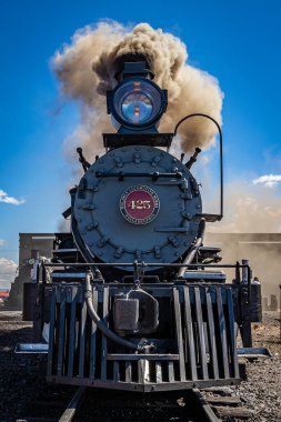 Antonito, CO - August 23, 2021: Coal burning Baldwin steam locomotive Denver and Rio Grande 425 during a public steam up in the Cumbres and Toltec Railroad yard at Antonito, Colorado. clipart
