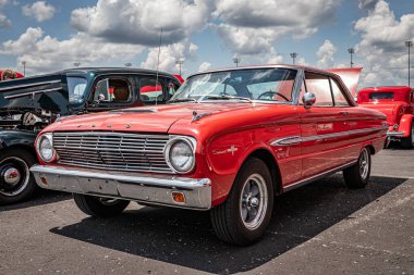 Lebanon, TN - May 14, 2022: Low perspective front corner view of a 1963 Ford Falcon Sprint Hardtop Coupe at a local car show. clipart