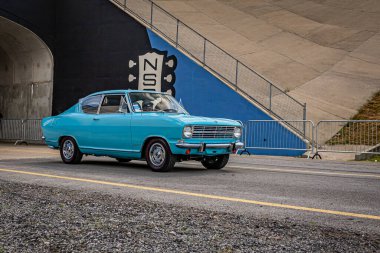 Lebanon, TN - May 14, 2022: Wide angle front corner view of a 1966 Opel Kadett B Kiemencoupe leaving a local car show.