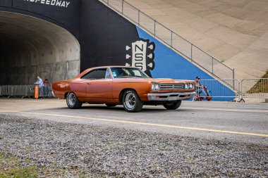 Lebanon, TN - May 14, 2022: Wide angle front corner view of a 1969 Plymouth Roadrunner 383 Hardtop Coupe driving on a road.