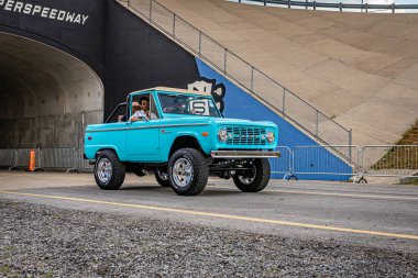 Lebanon, TN - May 14, 2022: Wide angle front corner view of a 1975 Ford Bronco Sport driving on a road.