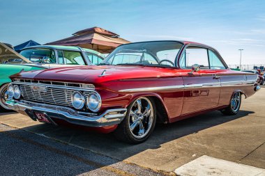Lebanon, TN - May 13, 2022: Low perspective front corner view of a 1961 Chevrolet Impala Sport coupe at a local car show.