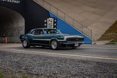 Lebanon, TN - May 14, 2022: Wide angle front corner view of a 1969 Chevrolet Camaro SS 350 Coupe driving on a road leaving a local car show.