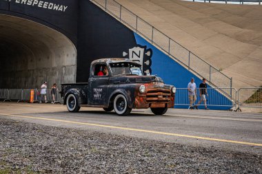 Lebanon, TN - May 14, 2022: Wide angle front corner view of an old 1953 Dodge B-series 1/2-Ton Truck driving on a road leaving a local car show.