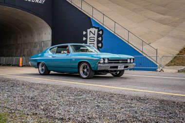 Lebanon, TN - May 14, 2022: Wide angle front corner view of a 1969 Chevrolet Chevelle SS 396 Coupe driving on a road leaving a local car show.