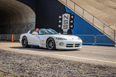 Lebanon, TN - May 14, 2022: Wide angle front corner view of a 1996 Dodge Viper RT/10 Convertible driving on a road leaving a local car show.