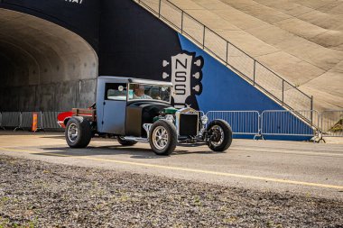 Lebanon, TN - May 14, 2022: Wide angle front corner view of a customized 1923 Ford T Bucket driving on a road leaving a local car show.