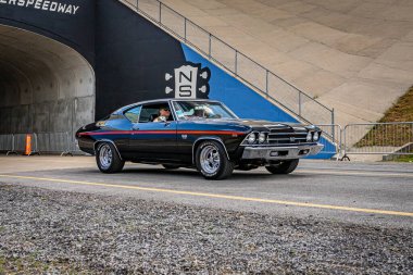 Lebanon, TN - May 14, 2022: Wide angle front corner view of a 1969 Chevrolet Chevelle SS 396 L78 Coupe driving on a road leaving a local car show.