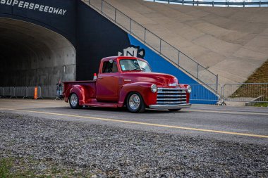 Lebanon, TN - May 14, 2022: Wide angle front corner view of a 1952 Chevrolet 3100 Pickup Truck driving on a road leaving a local car show.