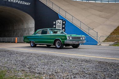 Lebanon, TN - May 14, 2022: Wide angle front corner view of a at 1967 Plymouth Belvedere GTX Hardtop driving on a road leaving a local car show.
