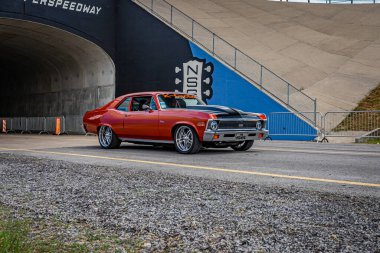Lebanon, TN - May 14, 2022: Wide angle front corner view of a 1972 Chevrolet Nova SS Coupe driving on a road leaving a local car show.