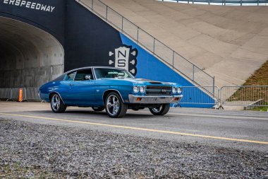 Lebanon, TN - May 14, 2022: Wide angle front corner view of a 1970 Chevrolet Chevelle Malibu SS454 coupe driving on a road leaving a local car show.