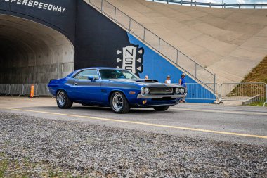 Lebanon, TN - May 14, 2022: Wide angle front corner view of a 1970 Dodge Challenger RT Hardtop Coupe driving on a road leaving a local car show.