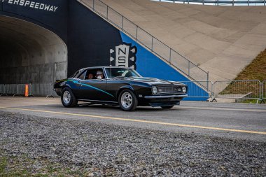Lebanon, TN - May 14, 2022: Wide angle front corner view of a Customized 1968 Chevrolet Camaro Z28 Coupe driving on a road leaving a local car show.