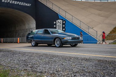 Lebanon, TN - May 14, 2022: Wide angle front corner view of a Customized 1992 Chevrolet Caprice Wagon driving on a road leaving a local car show.