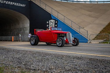 Lebanon, TN - May 14, 2022: Wide angle front corner view of a 1932 Ford Highboy Roadster Convertible driving on a road leaving a local car show.