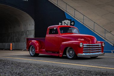 Lebanon, TN - May 14, 2022: Wide angle front corner view of a 1952 Chevrolet Advance Design 3100 Pickup Truck driving on a road leaving a local car show.