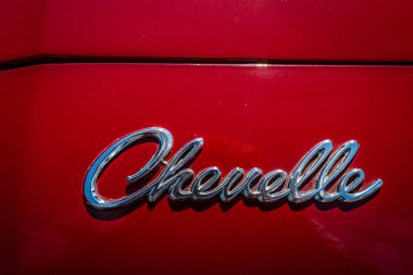 Lebanon, TN - May 13, 2022: Top perspective close up detail view of a 1968 Chevrolet Chevelle Malibu Hardtop Coupe hood emblem at a local car show.