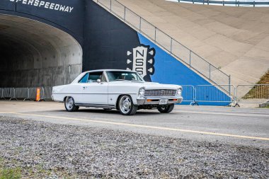 Lebanon, TN - May 14, 2022: Wide angle front corner view of a 1966 Chevrolet II Nova SS Hardtop Coupe driving on a road leaving a local car show.