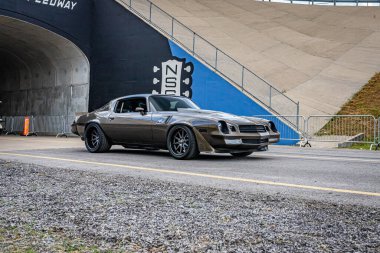 Lebanon, TN - May 14, 2022: Wide angle front corner view of a Customized 1979 Chevrolet Camaro Z28 Coupe driving on a road leaving a local car show.