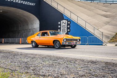Lebanon, TN - May 14, 2022: Wide angle front corner view of a Customized 1972 Chevrolet Nova SS Hardtop Coupe driving on a road leaving a local car show.