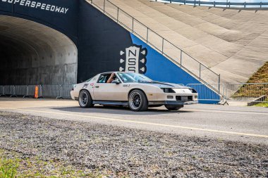 Lebanon, TN - May 14, 2022: Wide angle front corner view of a 1986 Chevrolet Camaro Z28 Coupe driving on a road leaving a local car show.